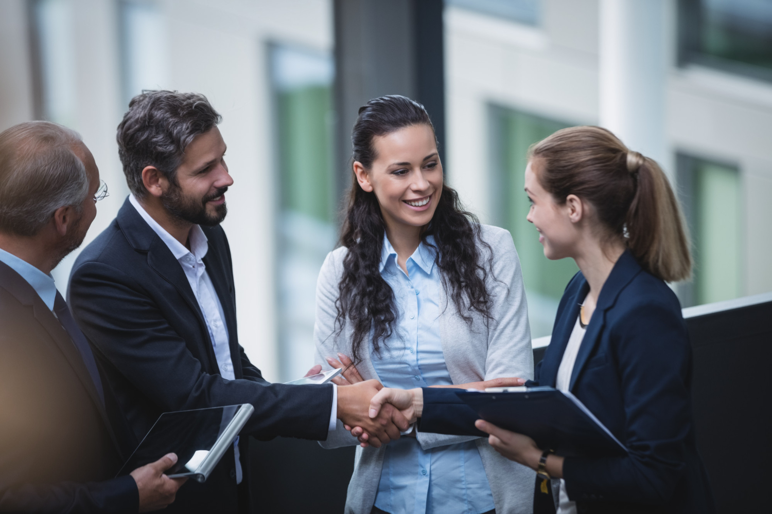 Hecht-Stout Insurance - Business professionals shaking hands after a discussion.